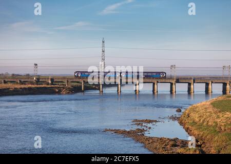 Scotrail class 156 sprinter train crossing the river Esk railway viaduct at Mossband on the  west coast mainline Stock Photo