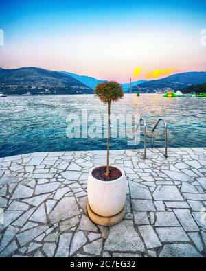 View on  Franjo Tudjman bridge from  beach Copacabana at sunset in Dubrovnik. Massive flowewpot at foreground. Location:  Dubrovnik, Dalmatia, Croatia Stock Photo