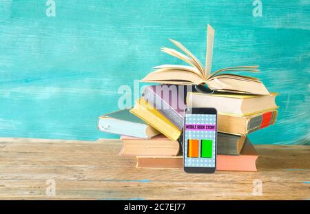 Stack of books and smartphone. online book shop, E- Book, book fair, reading,education concept. Stock Photo