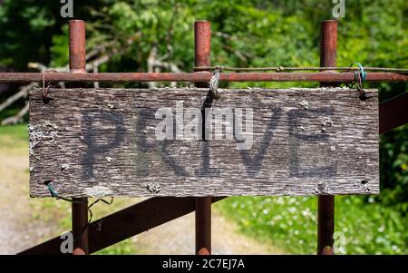 Privacy concept: Old wooden privé sign on a iron gate. Stock Photo