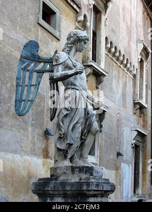 Castel Sant'Angelo, Rome, the statue of St. Michael the Archangel in the courtyard. A beautiful statue of an angel made of copper and stone. Stock Photo