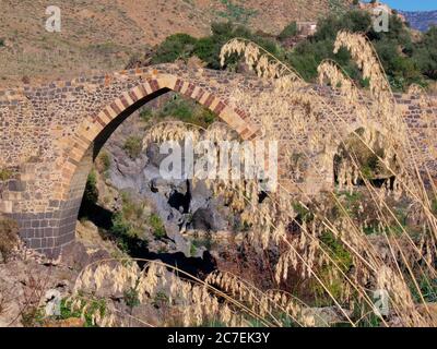 arabic arch of a bridge over the river Simeto, an example of ancient Sicilian architecture Stock Photo
