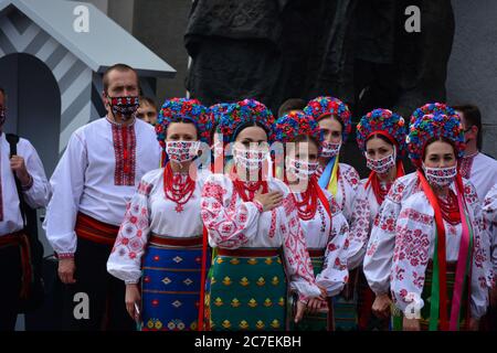 Coronavirus outbreak: Government prolongs adaptive quarantine until July 31 in Ukraine. Members of the Ukrainian national choir in folk costumes and e Stock Photo