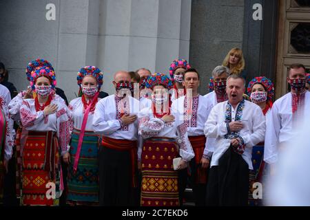 Coronavirus outbreak: Government prolongs adaptive quarantine until July 31 in Ukraine. Members of the Ukrainian national choir in folk costumes and e Stock Photo