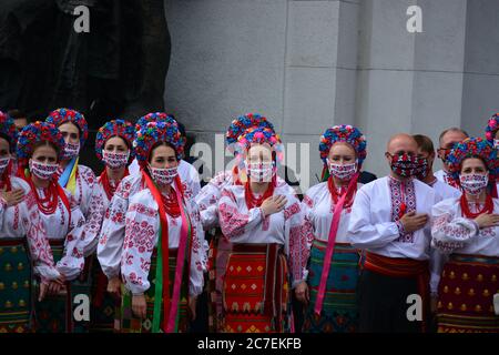 Coronavirus outbreak: Government prolongs adaptive quarantine until July 31 in Ukraine. Members of the Ukrainian national choir in folk costumes and e Stock Photo