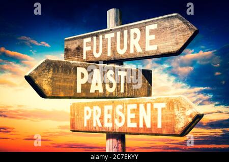 Future, past, present - wooden signpost, roadsign with three arrows Stock Photo