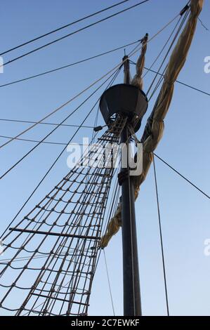 View from below of the main pole with the tail where the watchman went, hosting the horizon in a replica of a caravel from the 16th century Stock Photo