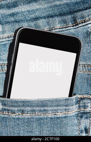 Mobile phone with blank mockup screen in the pocket of blue jeans Stock Photo