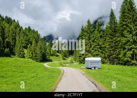 A hiking trail passing through a lush green alpine landscape near Oberstdorf, Germany Stock Photo