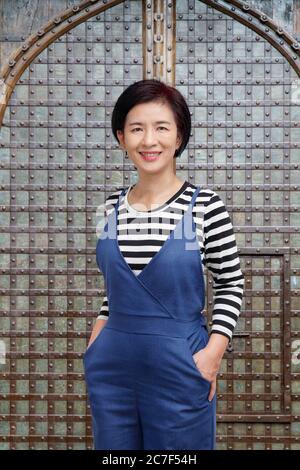middle aged asian woman smiling in casual clothes Stock Photo