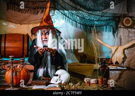 Happy Halloween - handsome Demon isolated on dark background. The crazy joker face. Devil man with skull with bloody face. Stock Photo