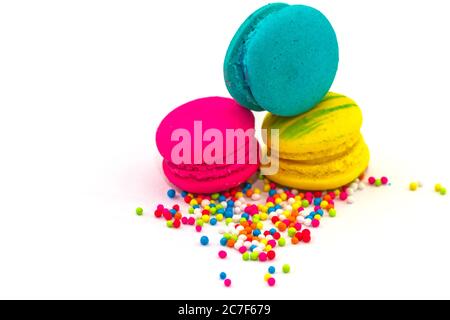 Sweet and colourful french macaroons or macaron  isolated on white backgroud with sugar topping. Stock Photo