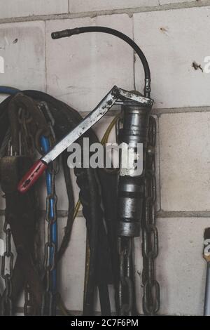 Vertical shot of garage equipment and tools hanging on the wall Stock Photo