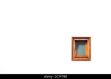 Open brown, wooden, faded, old window isolated on white wall background. Stock Photo