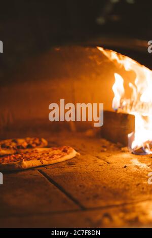 Vertical shot of bread dough near the fire in the stove Stock Photo