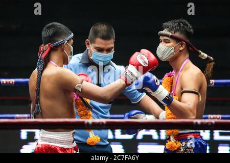 Pranakorn, Thailand. 15th July, 2020. Bai Phai Yotharak (L) and Rak Sommai Ngo Bangkapi (R) are seen in action during the Thai Boxing match that was held without spectators as a preventive measure against the spread of COVID-19 coronavirus at Rajadamnern Stadium. Credit: SOPA Images Limited/Alamy Live News Stock Photo