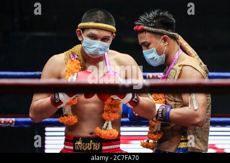 Pranakorn, Thailand. 15th July, 2020. Petch Lamsin (L) and Thongchai Petchungrueang (R) wearing face masks are seen before the Thai Boxing match that was held without spectators as a preventive measure against the spread of COVID-19 coronavirus at Rajadamnern Stadium. Credit: SOPA Images Limited/Alamy Live News Stock Photo
