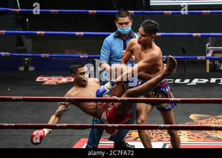 Pranakorn, Thailand. 15th July, 2020. Bai Phai Yotharak (L) and Rak Sommai Ngo Bangkapi (R) are seen in action during the Thai Boxing match that was held without spectators as a preventive measure against the spread of COVID-19 coronavirus at Rajadamnern Stadium. Credit: SOPA Images Limited/Alamy Live News Stock Photo