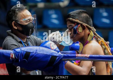 Pranakorn, Thailand. 15th July, 2020. Don Sak Sak Winai seen wearing a face mask before the Thai Boxing match that was held without spectators as a preventive measure against the spread of COVID-19 coronavirus at Rajadamnern Stadium. Credit: SOPA Images Limited/Alamy Live News Stock Photo