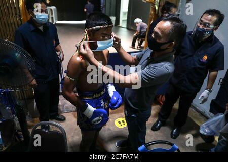 Pranakorn, Thailand. 15th July, 2020. Don Sak Sak Winai seen wearing a face mask before the Thai Boxing match that was held without spectators as a preventive measure against the spread of COVID-19 coronavirus at Rajadamnern Stadium. Credit: SOPA Images Limited/Alamy Live News Stock Photo