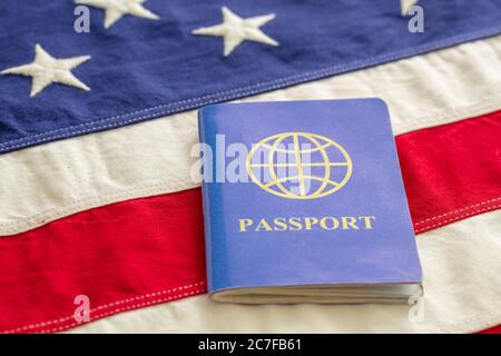 Blue passport on USA flag background, closeup view. Immigration, United States of America visa concept Stock Photo