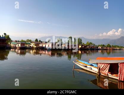 A scenic view of Shikara on the famous waters of Dal Lake in Srinagar city the summer capital of Jammu and Kashmir, India. Stock Photo