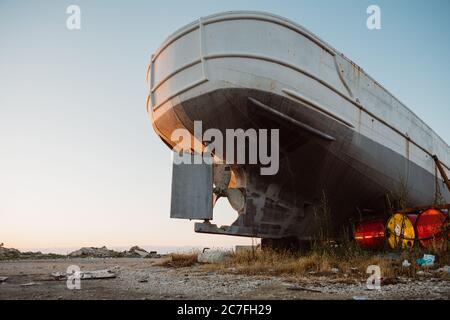 Detail of stern of the ship with propeller and rudder of old shipwreck on the coast of Greek island Zakynthos in Zakynthos harbor during summer day Stock Photo