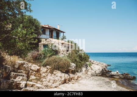 Coast house with view to the blue Ionian sea and clear blue sky on Greek island of Zakynthos during summer sunny day Stock Photo