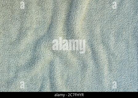 Texture terry cloth towel with pleats. Turquoise color Stock Photo