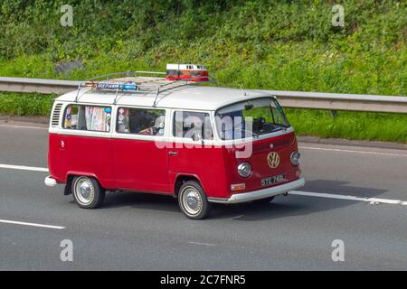 1972 70s Type 2 Red white VW Volkswagen LCV Motor Caravan;Touring Caravans and Motorhomes, 70s campervans on Britain's roads, RV leisure vehicle, mini bus family holidays, caravanette vacations, caravan holiday, van conversions, autohome, life on the road Stock Photo