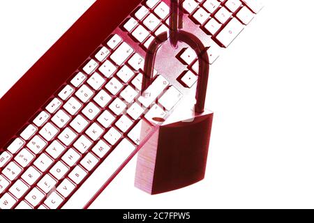 Unlocked transparent padlock on a chain with a keyboard in the background - security concept Stock Photo