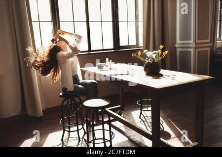 Young business woman working on laptop with phone from home  Stock Photo