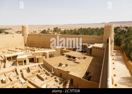 Raghba, Saudi Arabia, February 16 2020: View of the castle wall with corner tower of the castle in Raghba Saudi Arabia. Construction workers are on re Stock Photo