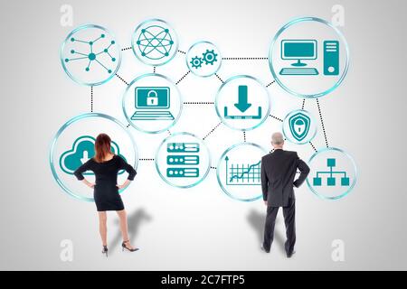 Cloud networking concept drawn on a wall watched by business people Stock Photo