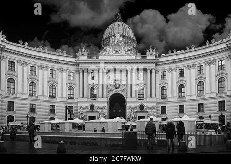 VIENNA, AUSTRIA - Dec 19, 2019: A greyscale shot of the Hofburg imperial palace under the cloudy sky in Vienna, Austria Stock Photo