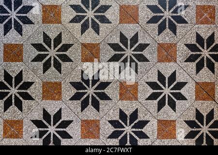 Old-fashioned antique brown beige floor tiles in a characteristic old farmhouse in the Netherlands as a full-screen background photo. Stock Photo
