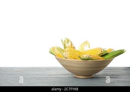 Bowl with corn on wooden table isolated on white background Stock Photo