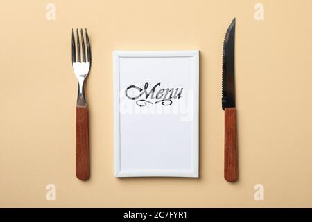 Frame with text Menu and cutlery on beige background Stock Photo