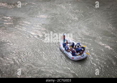 People enjoy a ride on a rafting boat on the River Ganges in the adventure town of Rishikesh in northern India Stock Photo