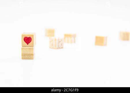 A heart drawn on the wood cubes. A Heart on the wooden cubes isolated on white Stock Photo
