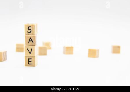 A word Save written on the wood cubes. Save lettering made of wooden cubes isolated on white Stock Photo