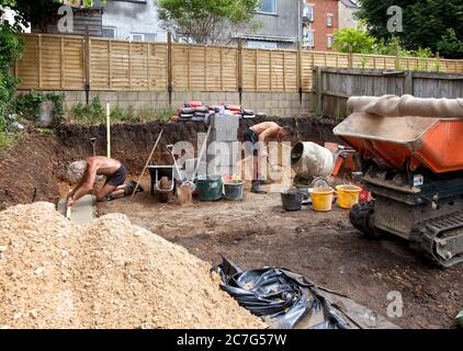 Two builders preparing foundations for garden studio Stock Photo