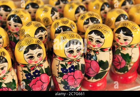 Colorful wooden Matryoshka dolls, also known as a Russian nesting dolls are on a counter of a gift shop. Popular souvenir Stock Photo