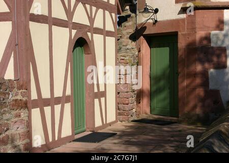Half-timbered house and sandstone arches on an old building in southern Germany Stock Photo
