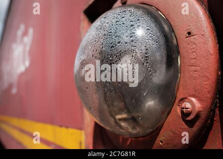 Close-up, shallow focus view of an anti-collision light system seen on the side of an old, British Royal Mail sorting train seen at a siding. Stock Photo