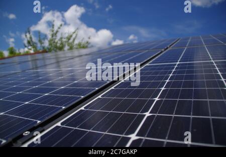 Photovoltaic energy station at home with sky clouds reflection. Solar panels on the roof. Ecology and environment protection concept. Renewable green Stock Photo
