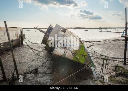 Abandoned boat beach, view of a derelict boat on its side sited on the beach at Burnham-On-Crouch in Essex, England, UK Stock Photo