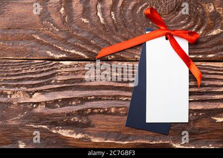 Clothing tag, label blank mockup template on a wooden background Stock Photo