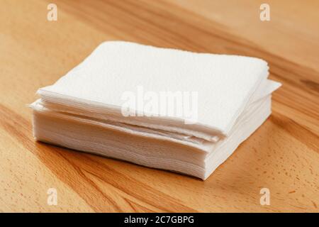 white paper napkin or tissue on the wooden table background. Stock Photo