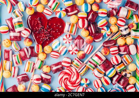 High angle shot of colorful candies and a heart-shaped lollipop - perfect for a cool wallpaper Stock Photo